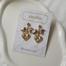 Load image into Gallery viewer, Gold laced heart and bow earrings