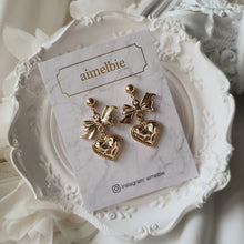 Load image into Gallery viewer, Gold laced heart and bow earrings