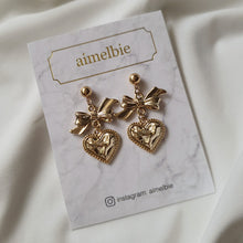 Load image into Gallery viewer, Gold laced heart and bow earrings